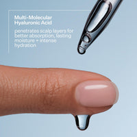 Close-up of a dropper with a drop of liquid on a finger, against a light blue background.