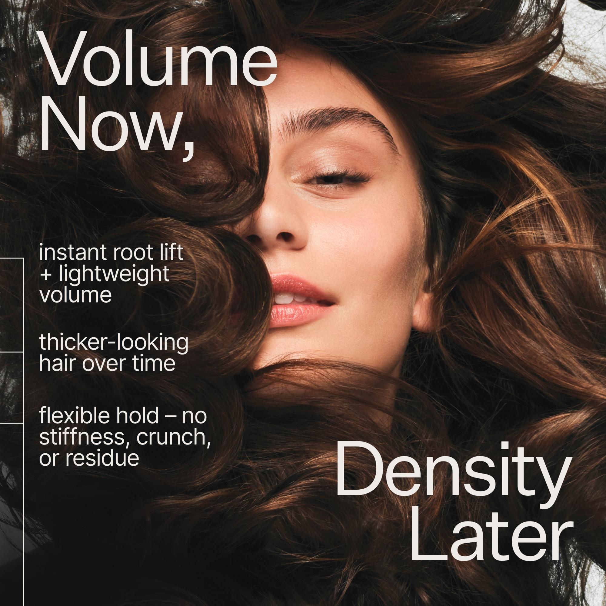 Promotional graphic for a hair product featuring a close-up of a woman with voluminous, dark brown hair. Large white text reads 'Volume Now, Density Later' with smaller feature callouts about instant root lift, lightweight volume, thicker-looking hair over time, and flexible hold with no stiffness, crunch, or residue.