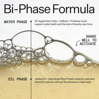 An informational graphic for a bi-phase formula hair treatment, showing a clear liquid with bubbles splitting into a water phase and an oil phase. Text explains the components: 2% apple stem cells, caffeine, and prebiotic inulin for scalp health, and jojoba oil and hydrolyzed rice protein for volume.