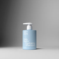 Blue shampoo bottle with pump on a gray background