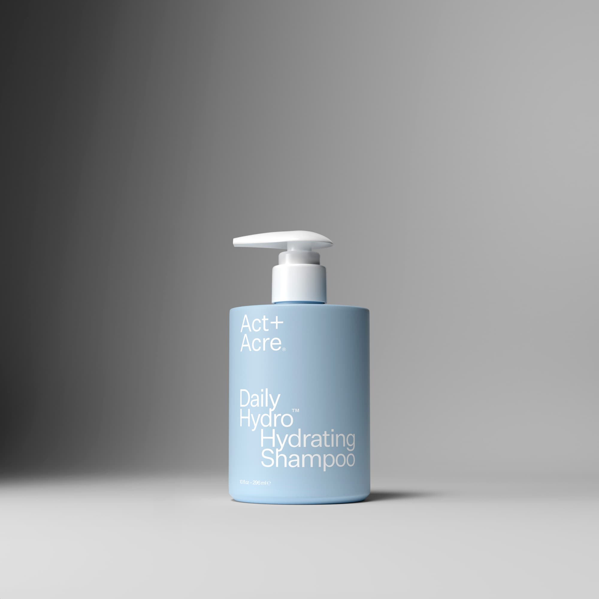 Blue shampoo bottle with pump on a gray background