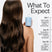 Person with long, wavy hair holding a bottle of conditioner with text on expected hair changes when using Act+Acre Daily Hydro™ Hydrating Conditioner.
