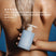 Person holding a bottle of Act+Acre Daily Hydro™ Hydrating Conditioner with a blue background.