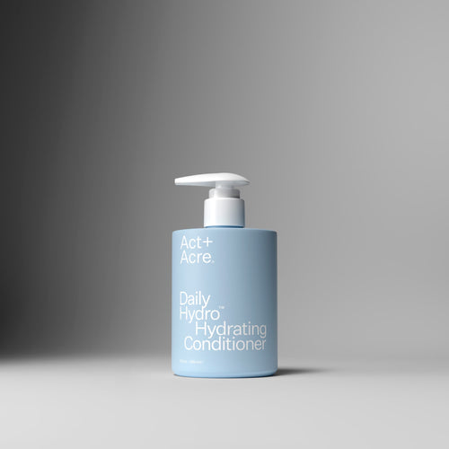 Blue bottle of Act+Acre Daily Hydro™ Hydrating Conditioner on a gray background