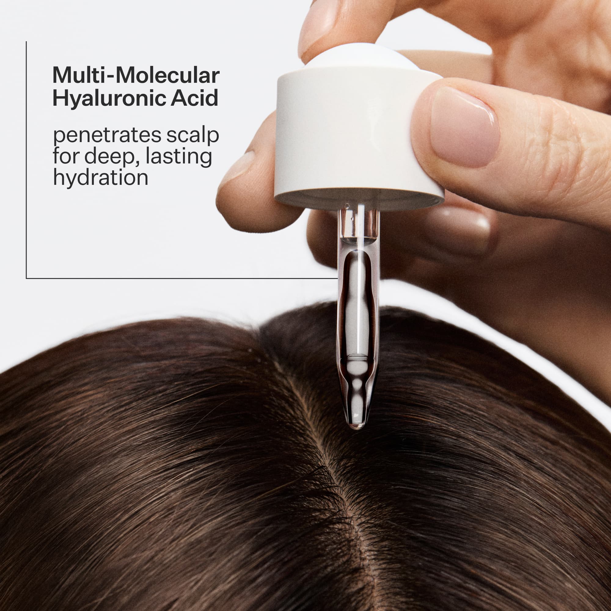 Hand holding a dropper with Daily Hydro™ Hydration Serum dropper over scalp, text about multi-molecular hyaluronic acid.