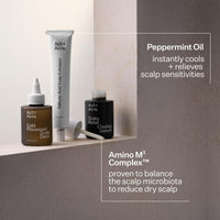 Three Act+ Acreo scalp care products arranged on a shelf against a neutral beige and taupe background: a brown bottle labeled Cold Processed Scalp Detox, a black bottle labeled Scalp Relief Cooling Serum, and a white tube labeled Silky Soft Scalp Elixir. Text callouts describe Peppermint Oil and Amino M3 Complex benefits.