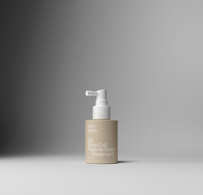 Haircare bottle with pump on a gradient gray background
