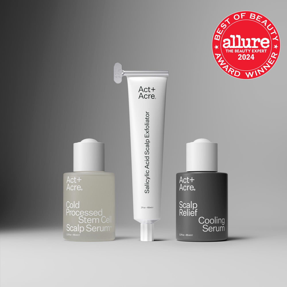 Three Act+ Acre. scalp care products are arranged on a gray gradient background: a pale serum bottle on the left, a white salicylic acid scalp exfoliator tube in the center, and a dark gray microbiome cooling scalp serum bottle on the right.