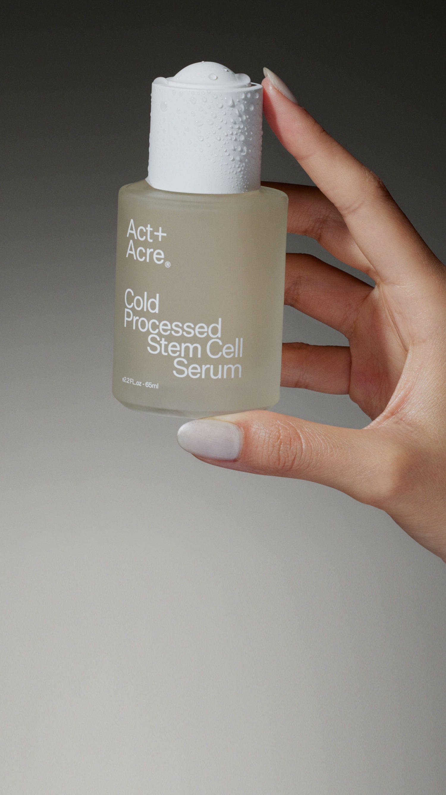 Hand holding Act+Acre Stem Cell Scalp Serum